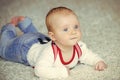 Infancy, newborn. Infant crawl on floor carpet. Child development concept. Baby with blue eyes on adorable face Royalty Free Stock Photo