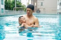 Infant adorable child boy swimming with father