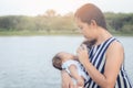 Infant baby on being fed by her mother drinking milk from bottle Royalty Free Stock Photo