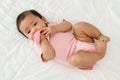 infant baby biting mushroom teether rubber toy on bed Royalty Free Stock Photo