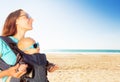 Infant in baby boy carriage with mom on sea beach Royalty Free Stock Photo