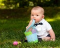 Infant baby boy playing with Easter eggs and basket Royalty Free Stock Photo