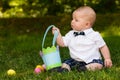 Infant baby boy playing with Easter eggs and basket Royalty Free Stock Photo