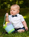 Infant baby boy playing with Easter eggs and basket Royalty Free Stock Photo