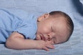 Infant baby boy sleeping on a blue blanket Royalty Free Stock Photo