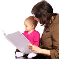 Infant baby girl discovering books with grandma