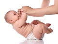 Infant baby girl kid in diaper is doing exercises to neck, torso lifts with adult coach Royalty Free Stock Photo