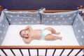 Infant baby laying in decorated cot Royalty Free Stock Photo