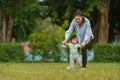 infant baby learn walking first step on grass field with mother holding hand helping in park Royalty Free Stock Photo