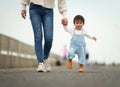 infant baby learn walking first step on pathway with mother holding hand Royalty Free Stock Photo