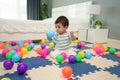 infant baby playing colorful plastic balls on jigsaw mat in bedroom Royalty Free Stock Photo