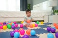 infant baby playing colorful plastic balls on jigsaw mat in bedroom Royalty Free Stock Photo