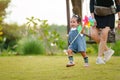 infant baby playing and walking first step on grass field with mother helping in park Royalty Free Stock Photo