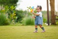 infant baby playing and walking first step on green grass in park Royalty Free Stock Photo