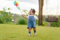 infant baby playing and walking first step on green grass in park Royalty Free Stock Photo