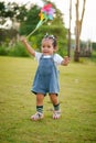 infant baby playing and walking first step on green grass in park Royalty Free Stock Photo