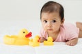 infant baby playing with yellow rubber duck toy on bed Royalty Free Stock Photo