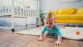 infant boy crawling on floor in