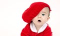 Infant Boy Sits lOOKING under his red hat
