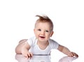 Infant child baby boy kid with blue eyes happy smiling screaming lying on a floor isolated on a white background