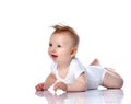 Infant child baby boy kid with blue eyes lying happy smiling screaming isolated on a white Royalty Free Stock Photo