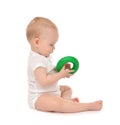 Infant child baby boy toddler playing holding green circle in ha