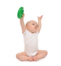 Infant child baby boy toddler playing holding green circle in ha