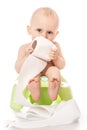 Infant child baby boy toddler sitting on potty toilet with a roll of toilet paper. stool pot isolated on a white background. Royalty Free Stock Photo