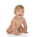 Infant child baby girl in diaper crawling happy looking at the c Royalty Free Stock Photo