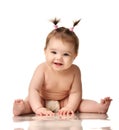 Infant child baby girl in diaper sitting happy laughing smiling isolated on a white