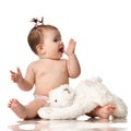 Infant child baby girl happy smiling in diaper with soft teddy bear toy isolated on white Royalty Free Stock Photo