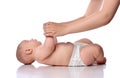 Infant baby girl kid in diaper is lying on her back start doing exercises to neck, torso lifts with adult coach Royalty Free Stock Photo