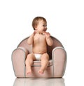 Infant child baby girl kid toddler in diaper sit in little armchair chair Royalty Free Stock Photo