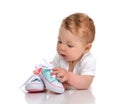 Infant child baby girl lying happy searching new shoes Royalty Free Stock Photo