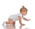 Infant child baby girl toddler crawling happy looking straight Royalty Free Stock Photo