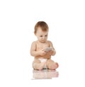 Infant child baby girl toddler playing with mobile cellphone happy smiling Royalty Free Stock Photo