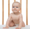 Infant child baby girl in wooden bed looking up Royalty Free Stock Photo