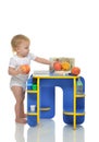 Infant child baby toddler kid happy standing and taking fruits p Royalty Free Stock Photo