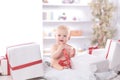 Infant child baby toddler kid sitting in presents gift for celebration Royalty Free Stock Photo