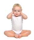 Infant child baby toddler sitting closed her hands over ears and