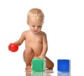 Infant child baby toddler sitting in diaper with green blue brick toy and red ball playing Royalty Free Stock Photo