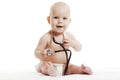 Infant child baby toddler sitting with medical stethoscope for physical therapy test isolated on a white background Royalty Free Stock Photo