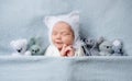 Infant child in bonnet with ears sleeping with toys Royalty Free Stock Photo
