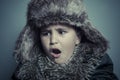 Infant child with fur hat and winter coat, cold concept and storm Royalty Free Stock Photo