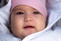Infant, childhood, emotion concept - close-up of cute smiling portrait face of brown-eyed chubby newborn awake toothless Royalty Free Stock Photo