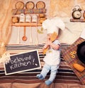 Infant cook baby boy portrait wearing apron and chef hat