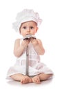 Infant cook baby portrait wearing apron and chef hat with metal ladle, isolated on a white background