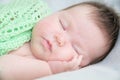 Infant cute baby sleeping portrait lying on arms