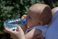 Infant drinking water from the bottle