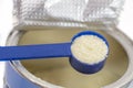 Infant formula in spoon and can